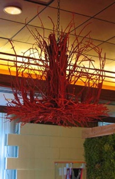 A custom red salvaged-branch chandelier courtesy of Atelier enhanced the look of giant art installations made of insulated concrete forms from Greenblock.