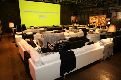 Rows of black and white sofas and chairs served as movie-theater-style seating and subtle branding.