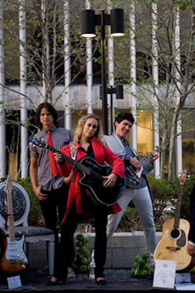 Models posed with collectible guitars, including one owned by Paul McCartney, that were later auctioned for charity. It was a silent auction, with results announced by M.C. Tim Gunn.