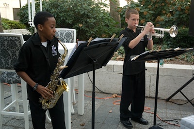 A sextet of middle-school jazz musicians played as guests crossed from the red carpet into the event.