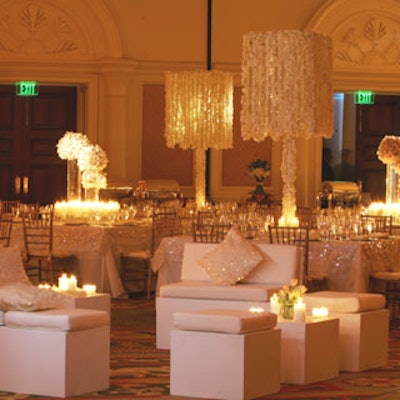 Large ball arrangements of cymbidium orchid blooms and tall lamp shades of dendrobium orchid garland lit from below by candles were the centerpieces for an event designed by Always Flowers.