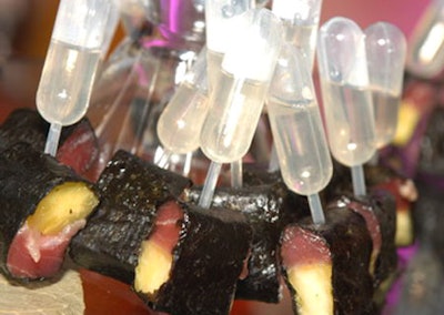 Pieces of ahi tuna and pineapple were wrapped in seaweed and skewered with a shot of plum sake for a twist on a traditional sushi roll.