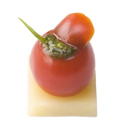 Pesto-filled cherry tomato on an aged Reggiano square, from Relish Caterers in New York.