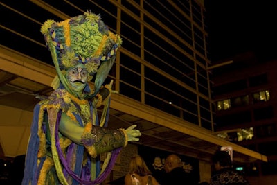 A stiltwalking Harlequin charmed guests with mime as he pointed the way from the Harman Center to the National Building Museum.