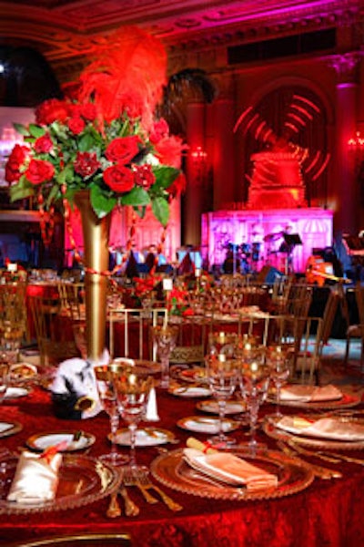 Towering arrangements of red roses topped tables.