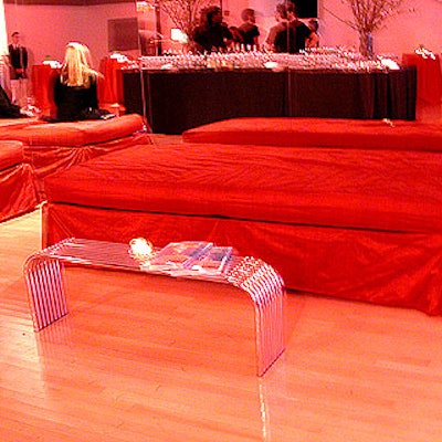 Musters & Company provided bed seats covered in red silk and chrome tables for the event.