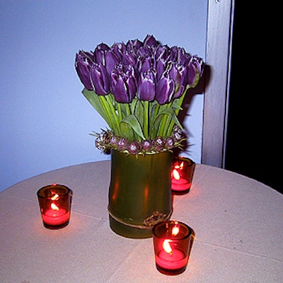 Adler made small, subtle flower arrangements in vases made of a piece of bamboo.