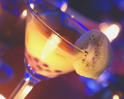 The Tampa Trifle, a layered dessert with blueberries, kiwi, yellow cake, and orange curd, was served in a martini glass.