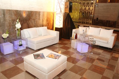 Seating areas featuring white suede couches and Lucite cube tables were provided by Balmelli Creative Events.