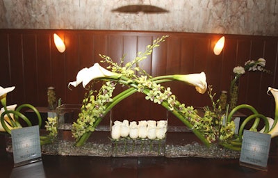 Balmelli Creative Events used a combination of calla lilies and white roses, along with greenery, to accent the bars and tabletops.