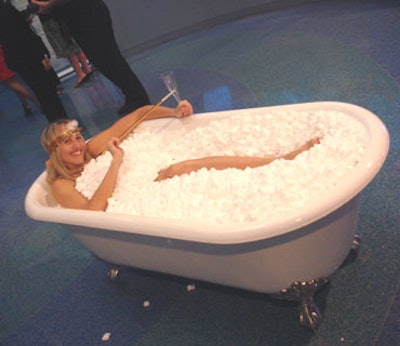 A 1920s flapper lounged in a pedestal bathtub resembling the gin bathtubs of the era and greeted guests as they entered.