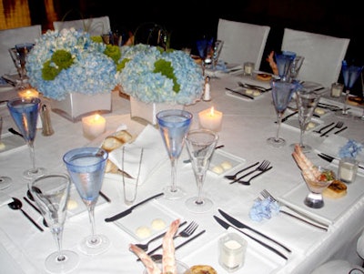 Cool blue and white were the colors of the evening, with blue-tinted water glasses, crisp white table linens and chair covers, and icy blue floral centerpieces.