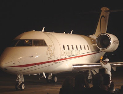 A private jet adorned with the evening's logo drove up to the hangar accompanied by mock ground controllers who assisted the models as they stepped off the plane.