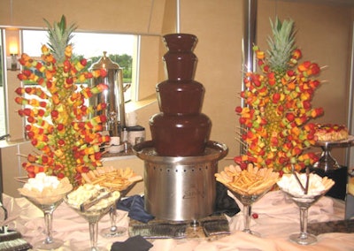 Alongside the pineapple-totem-poles pierced with fruit kebabs stood a chocolate fountain with various items for dipping, including marshmallows, bananas, and ladyfingers.