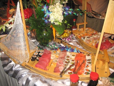 The seafood table featured two large sushi boats, adorned with fishnet sails, as well as shrimp cocktails, king crab legs, and a shrimp ceviche.