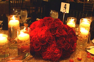 The Event Firm created low-profile, orb-shaped centerpieces with roses and hydrangeas in various shades of red and pink.