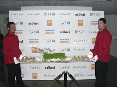 Sharply dressed waiters in white gloves served hors d'oeuvres such as baked Brie and beef empanadas on white rose petals on six-foot-long Lucite trays.