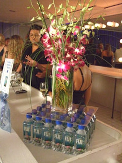 Tall flower arrangements, provided by 2Taste Catering, accentuated the sponsored Fiji water bottle display.