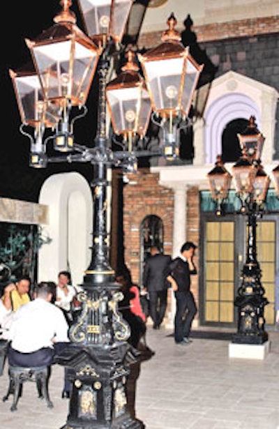 Intricately designed lampposts provided lighting for an outside courtyard where guests enjoyed fresh air with their drinks.