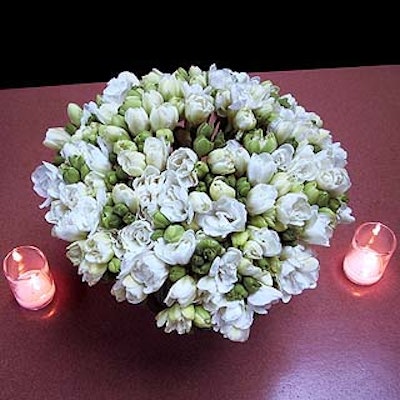 Michael George created small table centerpieces of white tulips.
