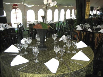 A single long stemmed phalaenopsis orchid highlighted each table in the dining area.