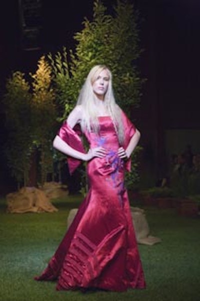 A model posed on the sod runway in a bamboo dress by designer Thien Lee.