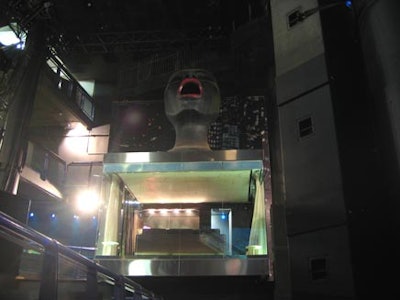 The Metropolis-inspired 20-foot head sits atop the super V.I.P. area.
