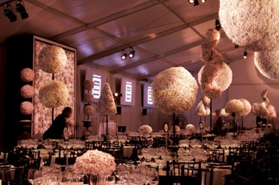 David Stark used 6,000 pounds of recycled paper to create topiary centerpieces, oversize chandeliers, and a podium backdrop.