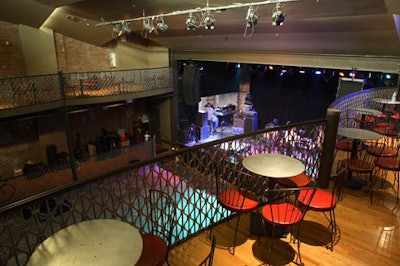 A balcony on the second floor overlooks the stage and the central space.
