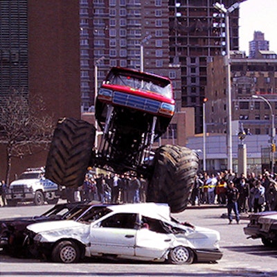 A monster truck from Wildfire Motorsports crushed discarded cars provided by Mid-Island Auto Wrecking at the New York International Auto Show opening day ceremony in front of the Javits Center.