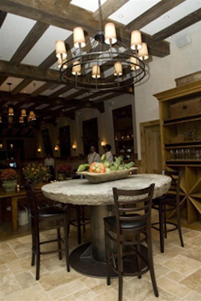 In addition to wood-beamed ceilings, stone accents, and wrought-iron chandeliers, Irving Mill features a millstone table.