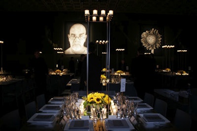 Tall steel platforms with votives towered over dinner tables and helped frame the large portraits on the walls.