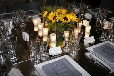 Custom-built tables featured a perimeter of frosted glass with a reflective square mirror in the middle to frame the votives and provide subtle light to the room.