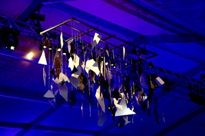 Chandeliers made from shards of smoked clear Lucite and mirrored black and white Lucite hung overhead, reflecting light into all areas of the tent.