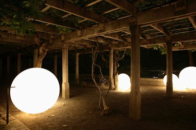 Illuminated globes—glo balls from Taylor Creative—sat in groups outside the tents, lighting the way to the entrance.