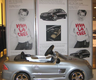 A mini model of a Mercedes—the carmaker is a partner in the Key to the Cure campaign—was part of a display featuring the 'Viva La Cure' campaign posters and a full-size Mercedes.
