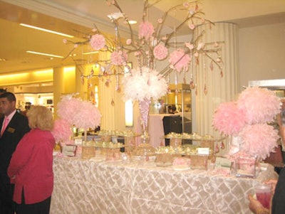 A centerpiece of pink feathers, flowers, and crystals kept the pink theme alive at the station created by A Joy Wallace Catering Production & Design Team.