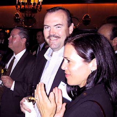 Michael McCarty (left), Charlie Palmer and Lisa Palmer awaited the drawing for a trip to France.