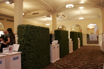 Artificial hedges divided the cocktail area and drew attention to the auction items.