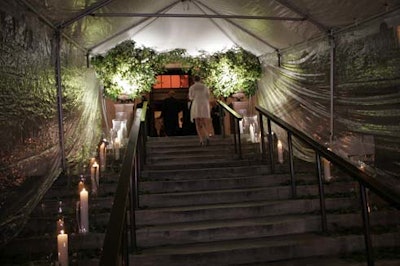 Large hurricane vases lined the main-entrance stairway; inside, smaller candles embellished the wide steps to the dinner space.