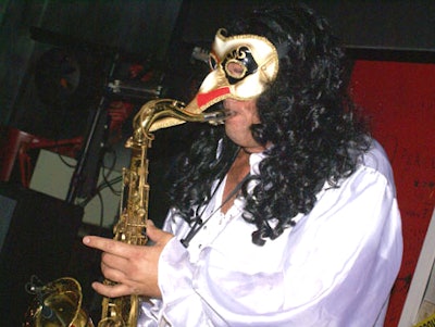 A mysterious, Venetian-masked saxophonist jammed with Funk Master Dima to entertain guests.