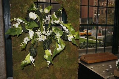 Arrangements of large goddess calla lilies poked through the circular holes in the stage's panels.