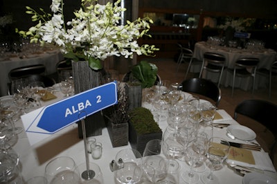 Wilson also used moss in the tabletop centerpieces and replaced the traditional table numbers with traffic-sign-style cards.