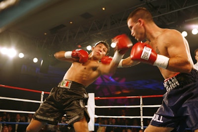 Leo Martinez (left) scored a blow to Dean White as the first of four matches played on five projection screens placed around the ballroom.