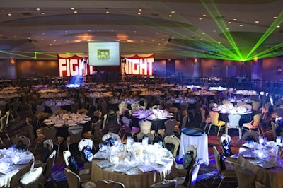 Nearly 200 tables filled the Hilton's sunken ballroom for Fight Night, where place settings were simple in black, white, and tan, but darting laser beams set an expectant mood for the eventual boxing matches.