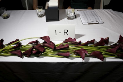 Burgundy calla lilies lined the check-in table.
