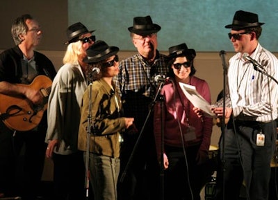 Participants sing the blues about work with Face the Music's blues band.