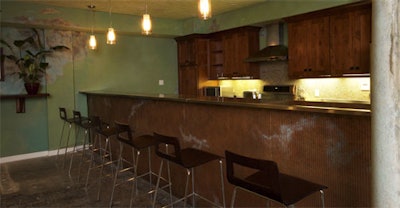 A kitchen and bar area is fully stocked.