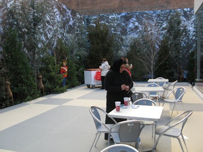 A forest-themed backdrop lined with real trees and Christmas props surrounded the outdoor terrace and hid the back-of-house area.