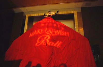 An opera singer performed during the cocktail hour perched above the ballroom entrance, which was hidden beneath her expansive gown.